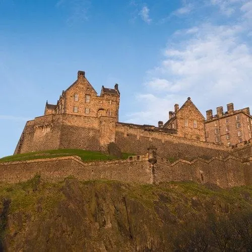 Low angle view of the stone ramparts and buildings of Edinburgh Castle on Castle Rock.